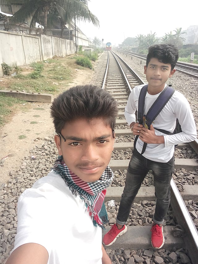 Al Rafi taking a selfie on a rail line in Dhaka`s Kuril and Imran Hossain poses for it on 16 February, 2020. Photo: Collected