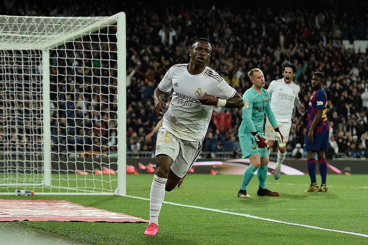 Real Madrid's Brazilian forward Vinicius Junior (C) celebrates after scoring a goal during the Spanish League football match between Real Madrid and Barcelona at the Santiago Bernabeu stadium in Madrid on 1 March, 2020.