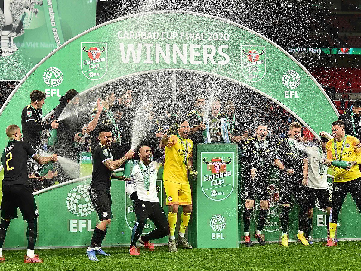 Manchester City's players celebrate their win with champagne after the English League Cup final football match between Aston Villa and Manchester City at Wembley stadium in London on March 1, 2020. Manchester City won the game 2-1. AFP