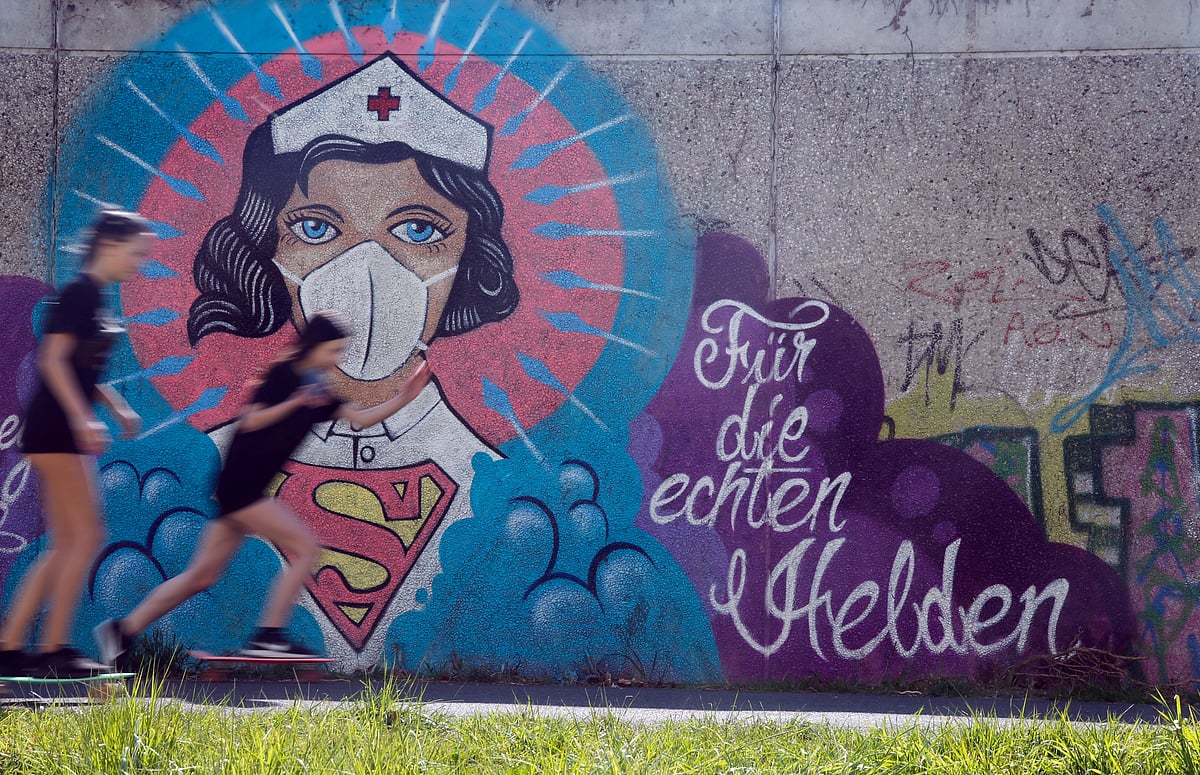 A graffiti showing a nurse with a protective mask and a Superman shirt is sprayed on a wall with the slogan "for the real heroes", as the spread of the coronavirus disease (COVID-19) continues in Hamm, Germany.