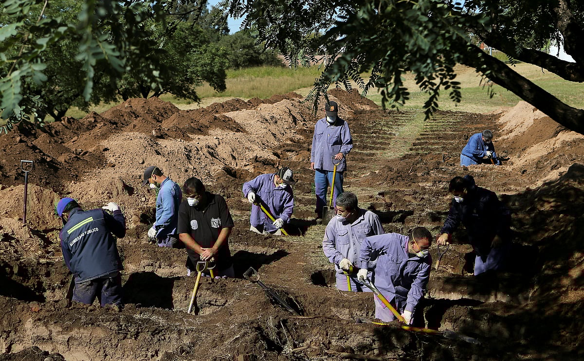 Gravediggers open new graves at the San Vicente cemetery, during the coronavirus disease (COVID-19) spread, in Cordoba, Argentina 13 April 2020.