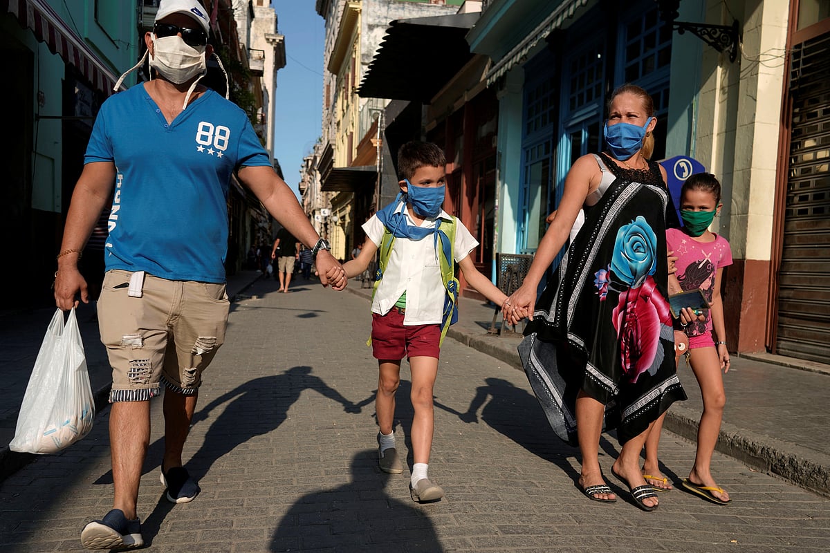 Susana Valdes, (2-R) takes her children from school together with her husband amid concerns about the spread of the coronavirus disease (COVID-19) outbreak, in Havana, Cuba.
