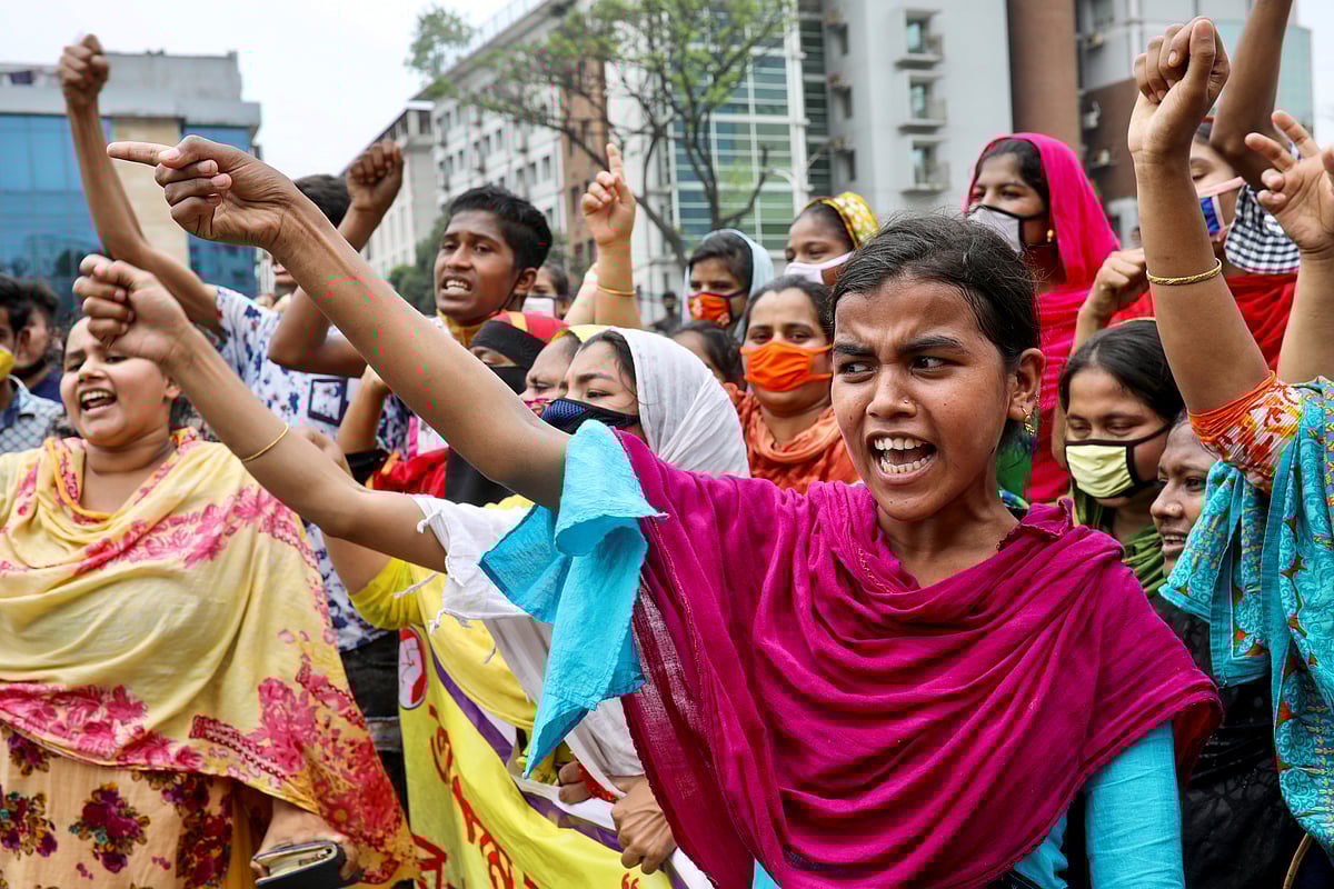 Garments workers shout slogans as they block a road demanding their due wages during the lockdown amid concerns over the coronavirus disease (COVID-19) outbreak in Dhaka, Bangladesh, 15 April, 2020.
