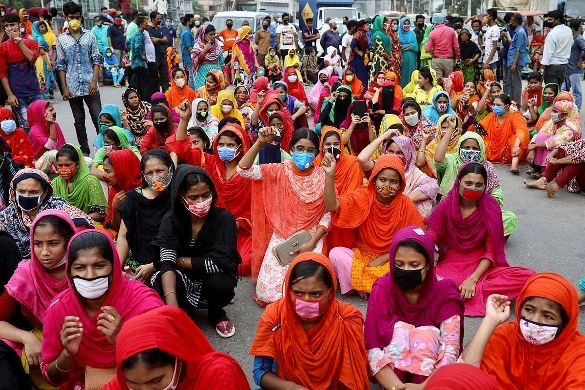 Garments workers shout slogans as they block a road demanding their due wages during the lockdown amid concerns over the coronavirus disease (COVID-19) outbreak in Dhaka, Bangladesh, April 2020.