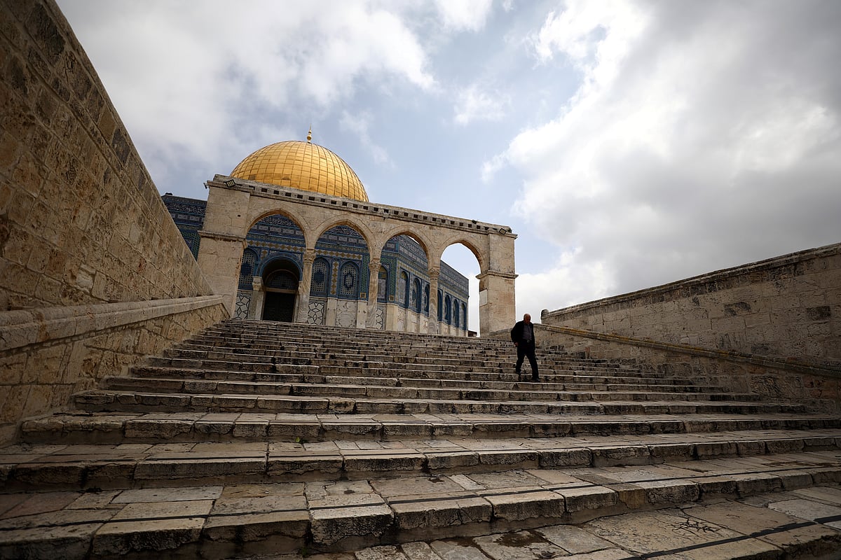 A man walks in front of the Dome of the Rock in the compound known to Muslims as Noble Sanctuary and to Jews as Temple Mount in Jerusalem's Old City, after Muslim clerics shut the doors of Al-Aqsa mosque and the Dome of the Rock until further notice as a precaution against coronavirus on 15 March.