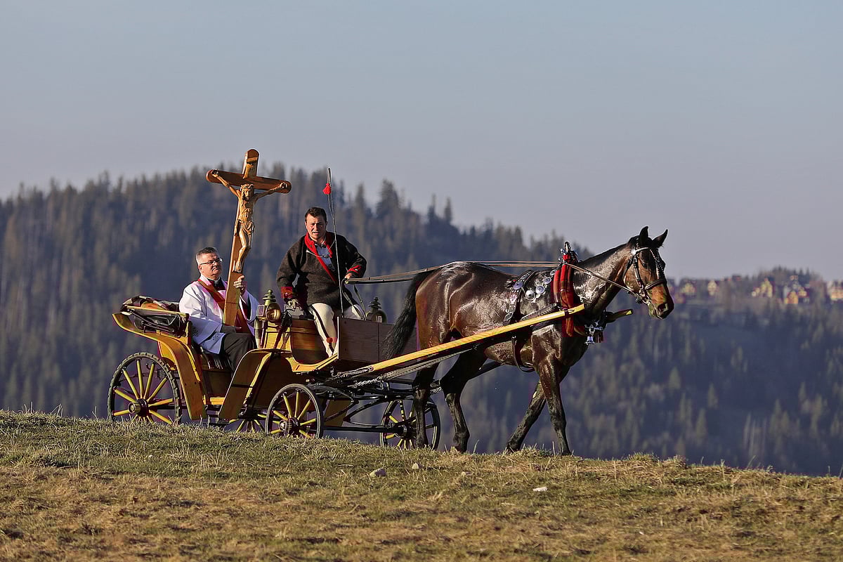 A priest carries a cross in a horse-drawn cart during Good Friday celebrations in the mountains following the spread of coronavirus disease (COVID-19), in Zakopane, Poland 10 April 2020.