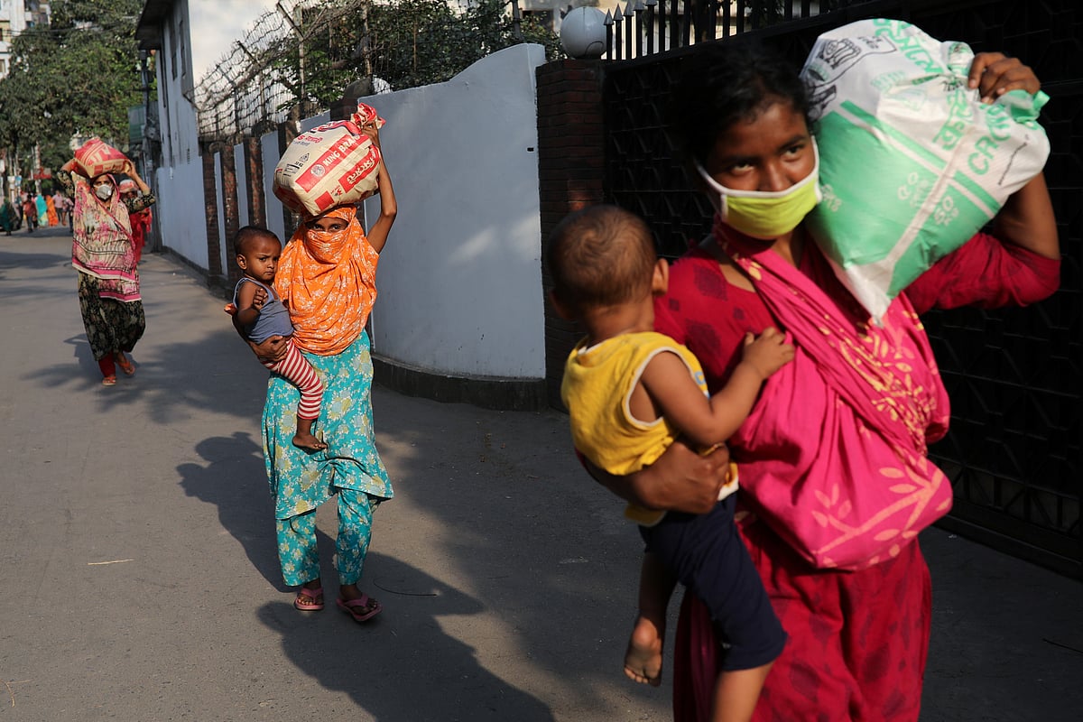 Women carry relief supplies amid the coronavirus disease (COVID-19) outbreak in Dhaka, Bangladesh