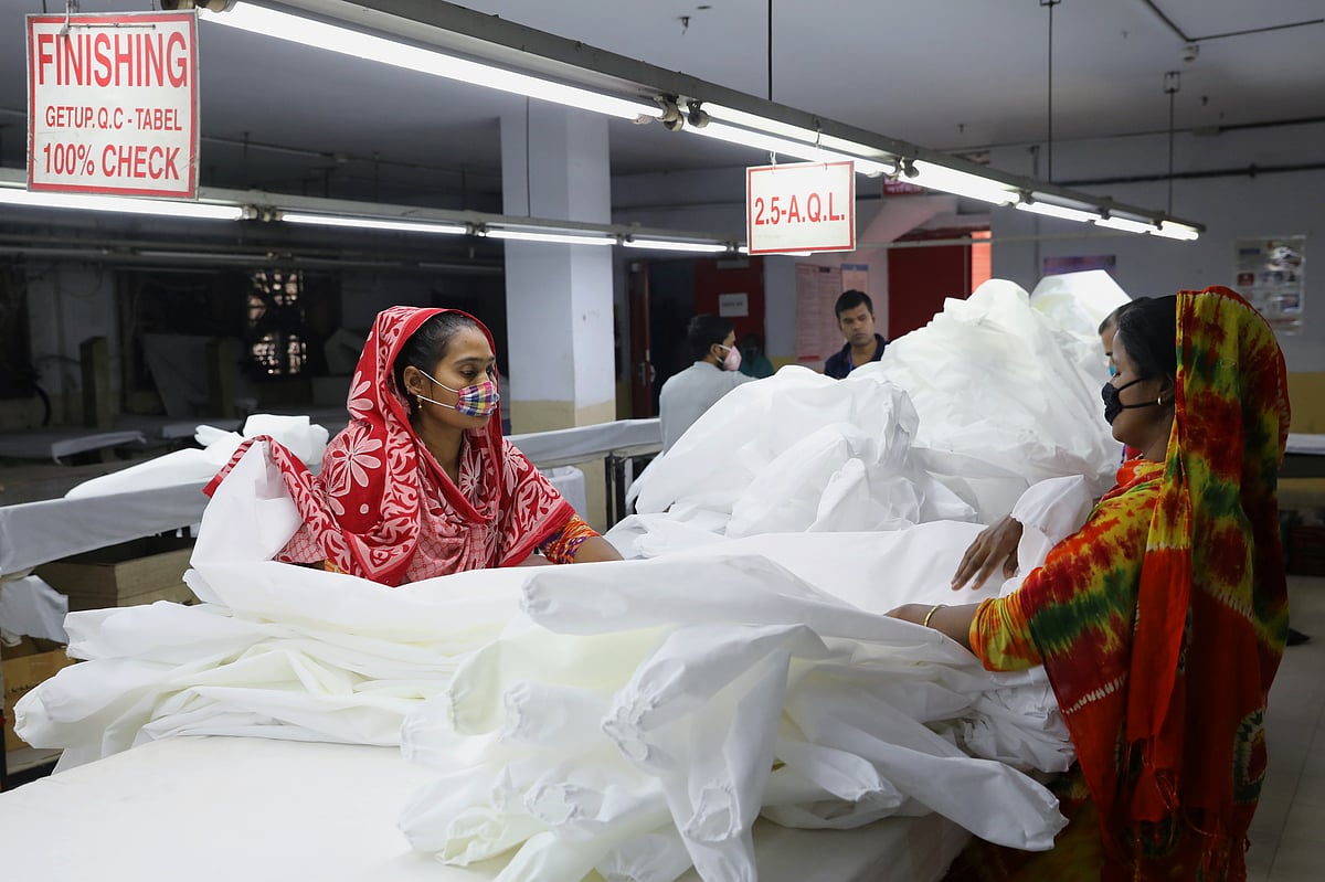 Bangladeshi garment workers make protective suit at a factory amid concerns over the spread of the coronavirus disease (COVID-19) in Dhaka, Bangladesh, 31 March 2020.