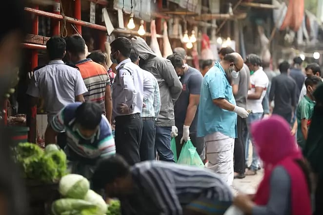 People shop at Hatirpul kitchen market flouting social distancing rules amid coronavirus outbreak in Dhaka on 8 April 2020.