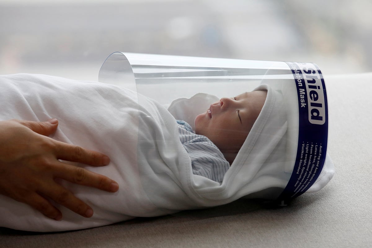 Newborn baby Phuc An, wearing a protective face shield, is seen before leaving home for his vaccination, during the coronavirus disease (COVID-19) outbreak in Hanoi, Vietnam 13 April 2020.