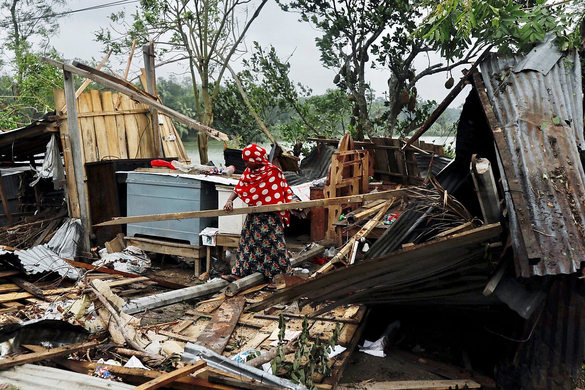 A woman clears her house that was demolished by the cyclone Amphan in Satkhira, Bangladesh 21 May, 2020. Photo: Reuters