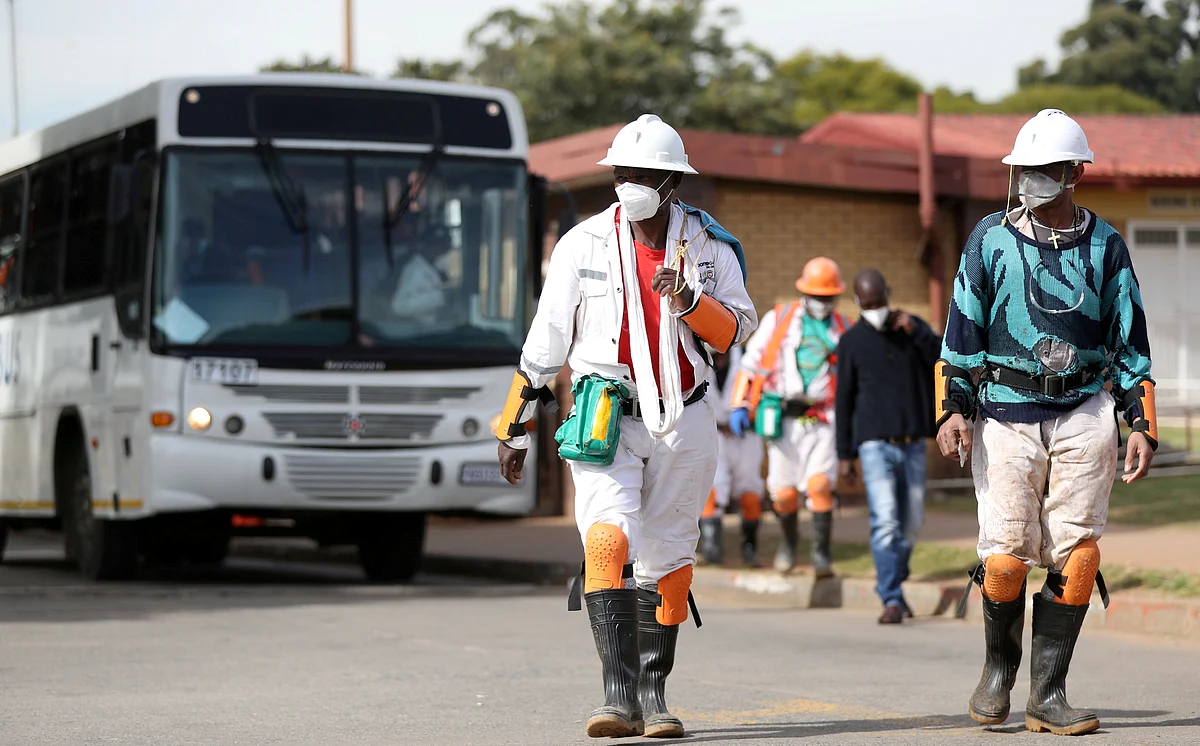 Mine workers wearing face masks arrive ahead of their shift, amid a nationwide coronavirus disease (COVID-19) lockdown, at a mine of Sibanye-Stillwater company in Carletonville, South Africa on 19 May.