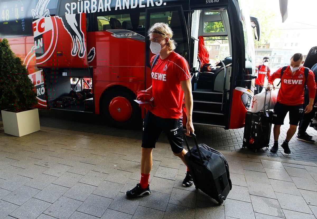Cologne's Sebastiaan Bornauw wears a protective face mask as he enters a hotel in Cologne, as the team goes into quarantine before the first round of Bundesliga games resume, following the outbreak of the coronavirus disease (COVID-19) .