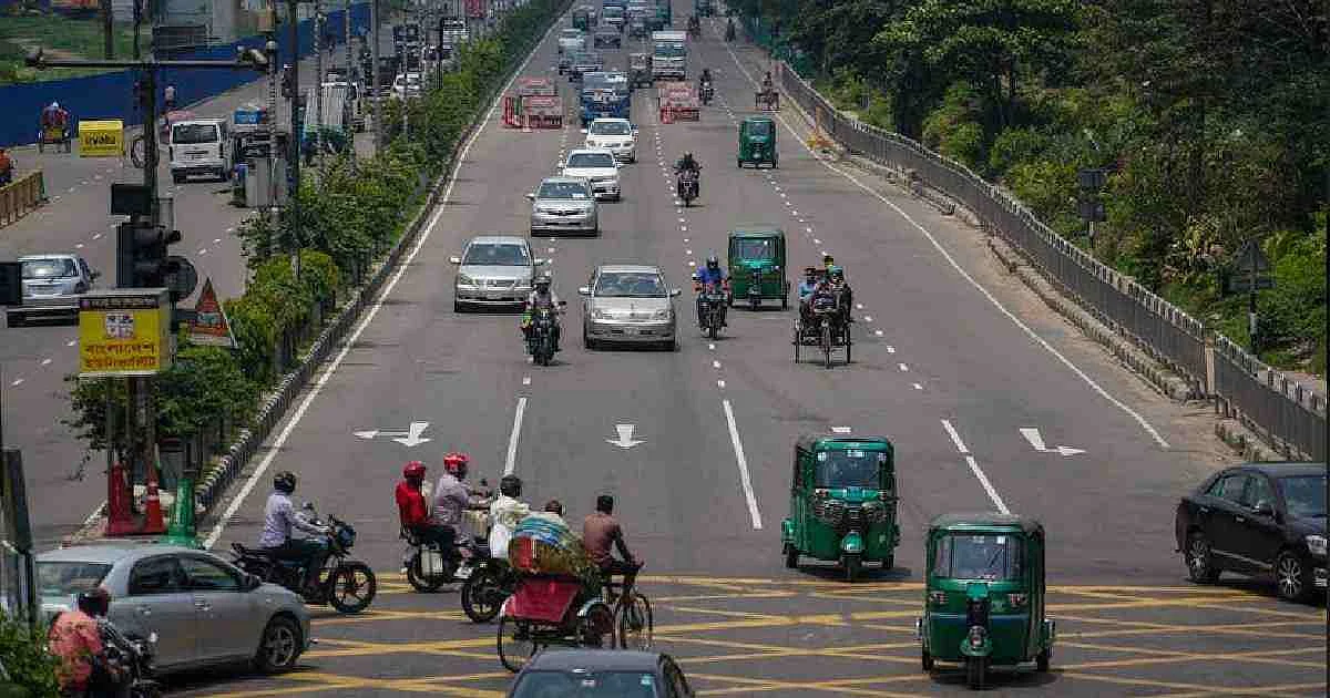 Vehicles ply along Dhaka street