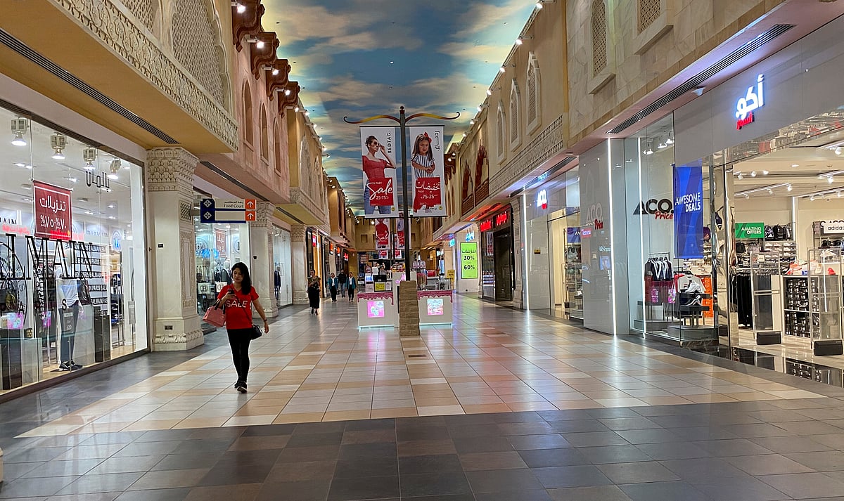 A woman walks in an almost empty mall amid the outbreak of coronavirus disease (COVID-19), in Dubai, United Arab Emirates, 22 March 2020.
