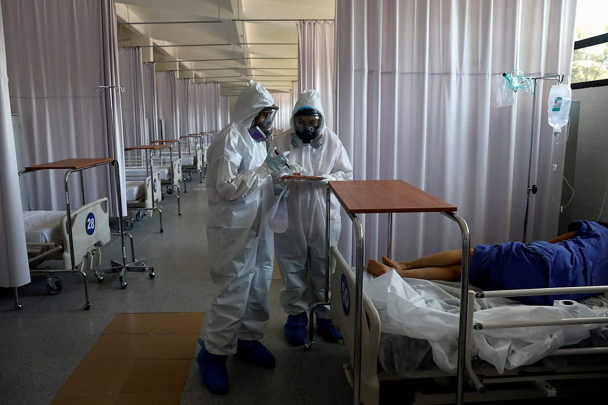 Medical staff are seen looking after a patient inside the provisional military hospital of the Campo Militar No. 1, which takes care of patients with symptoms of the coronavirus disease (COVID-19) in Mexico City, Mexico 9 June 2020.
