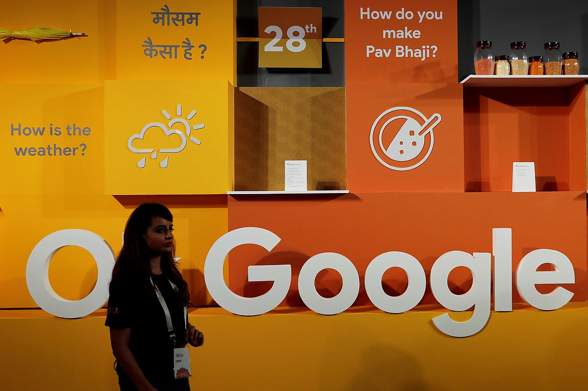 A woman walks past the logo of Google during an event in New Delhi, India, 28 August 2018.