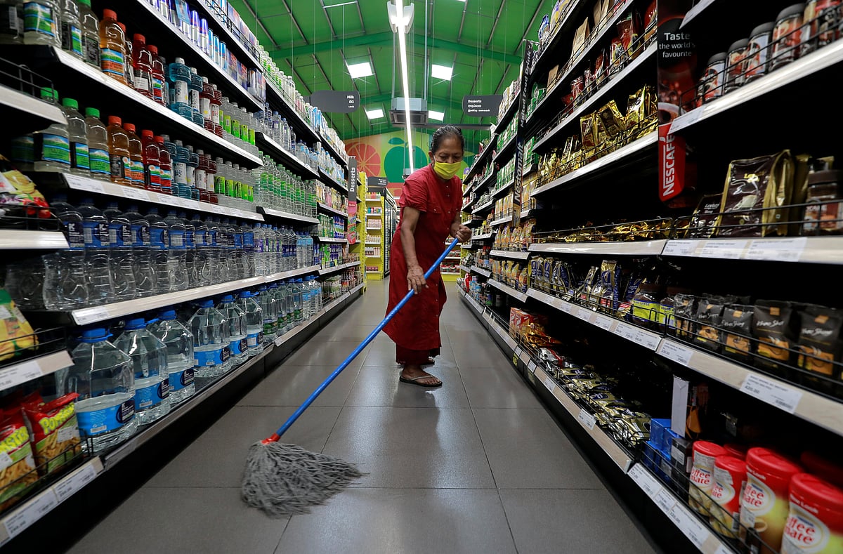 A worker wipes the floor with disinfectants at a Keels super market, amid concerns about the spread of the coronavirus disease, in Colombo.