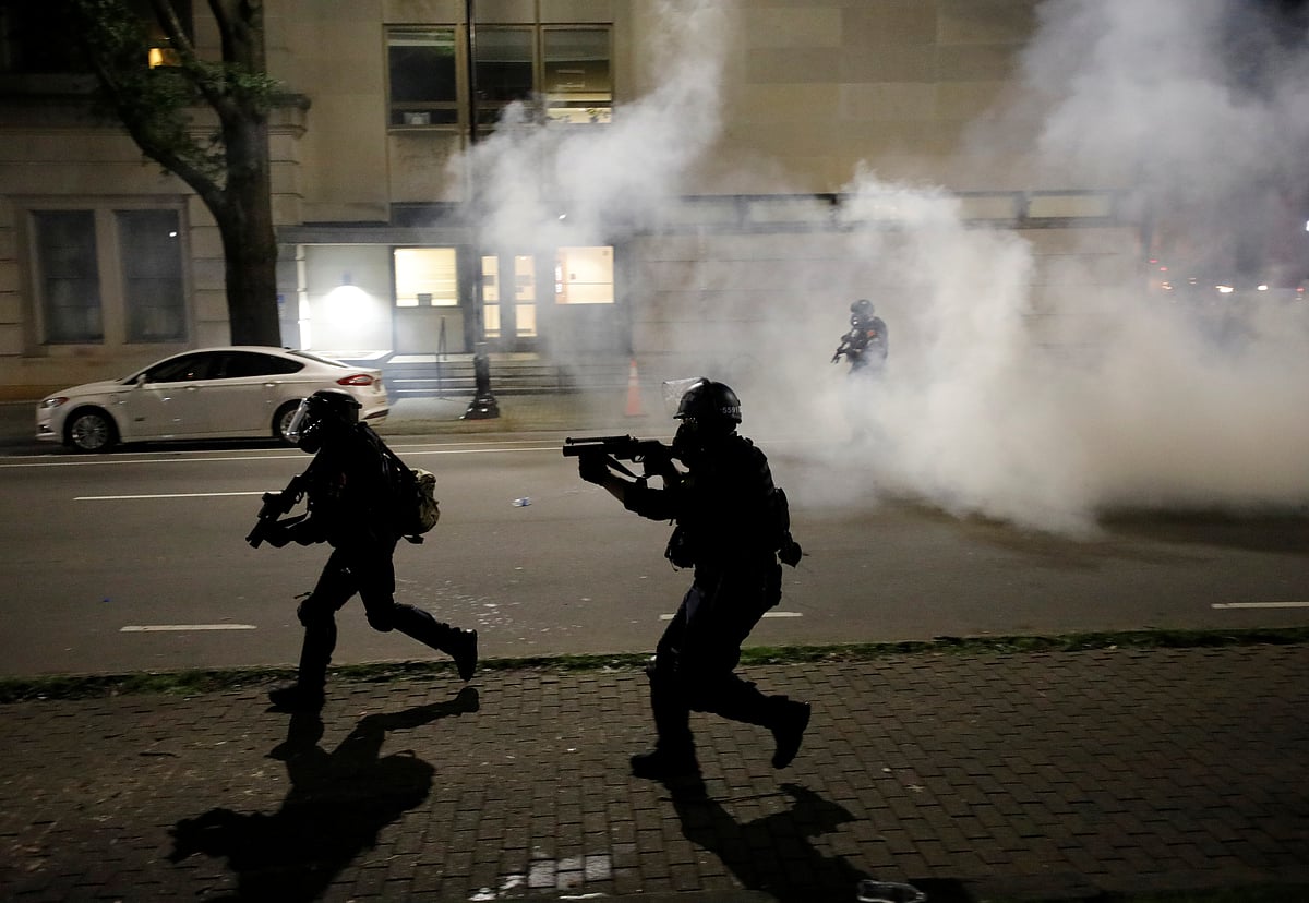 Riot police run at protesters while firing tear gas during nationwide unrest following the death in Minneapolis police custody of George Floyd, in Raleigh, North Carolina, US, 31 May 2020.