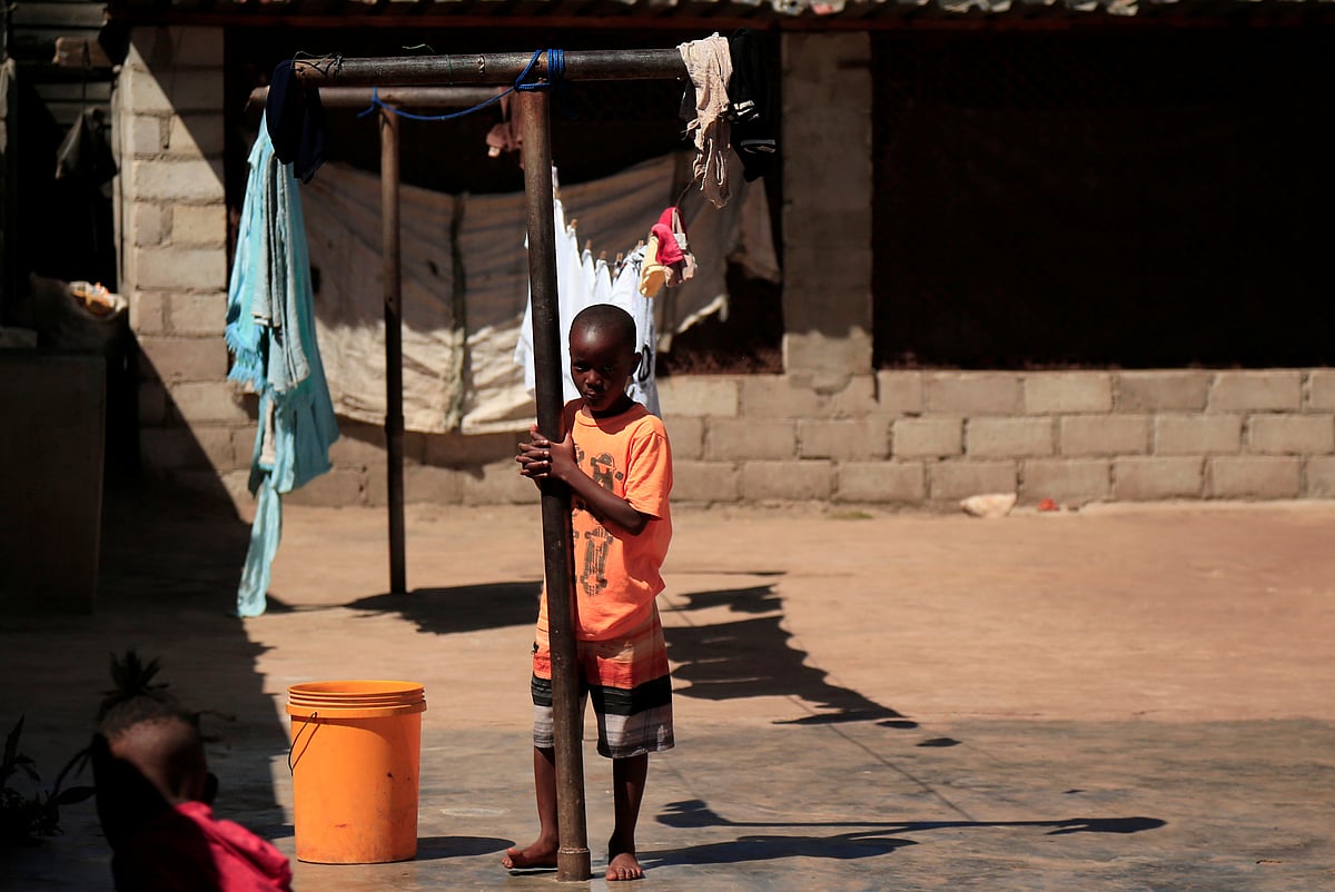 A child plays outside his family's home during a nationwide lockdown to help curb the coronavirus disease (COVID-19) spread in Harare, Zimbabwe, 9 May 2020.