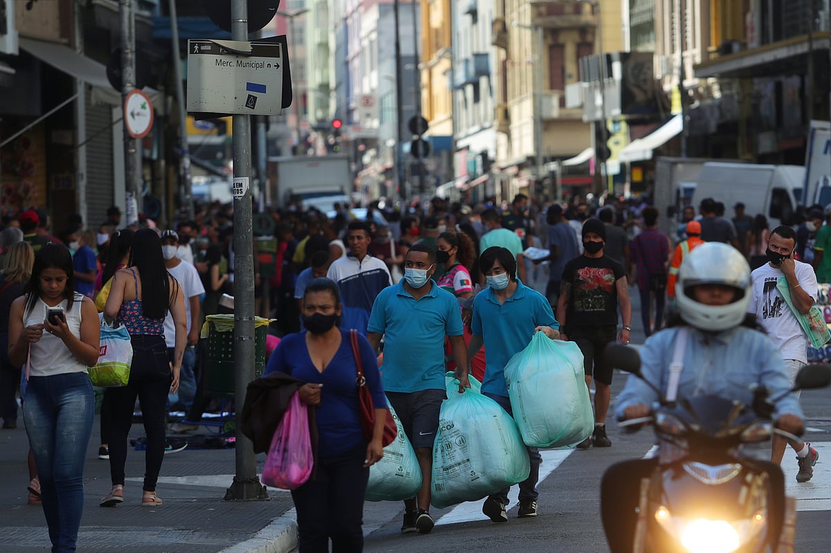 People walk with bags at a popular shopping street amid the coronavirus disease (COVID-19) outbreak, in Sao Paulo, Brazil, on 19 June 2020.