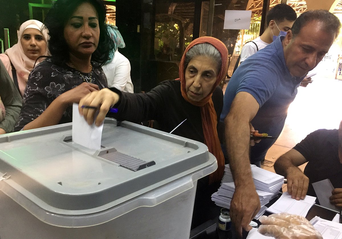 A woman casts her vote inside a polling station during the parliamentary elections in Damascus, Syria on 19 July.
