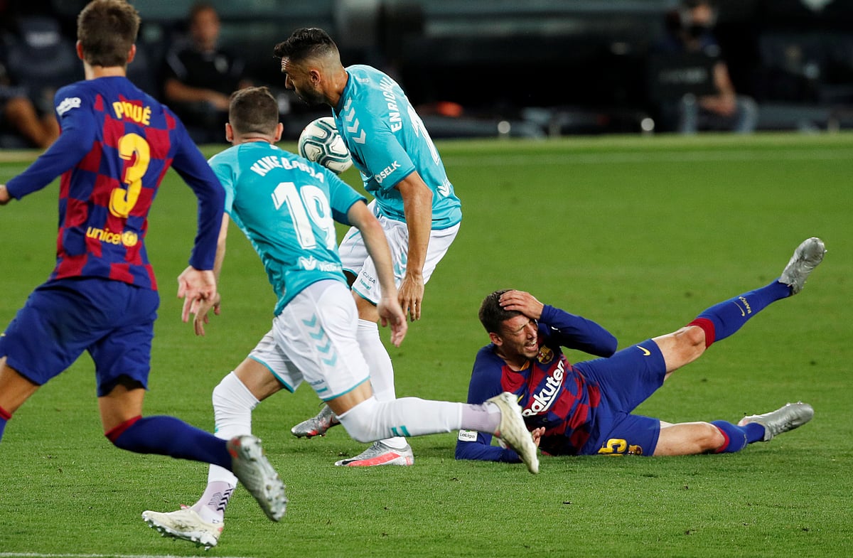 Osasuna's Enric Gallego in action with Barcelona's Clement Lenglet at Camp Nou, Barcelona, Spain at July 2020
