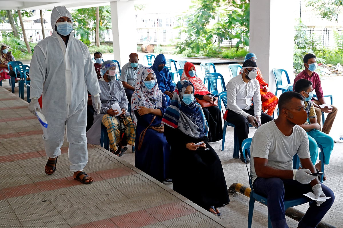 People sit as they come to a coronavirus testing center in the Mugda Medical College and Hospital as the coronavirus disease (COVID-19) outbreak continues in Dhaka, Bangladesh, 2 July 2020