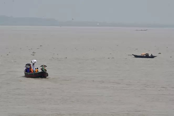 People cross river Padma swelling with water
