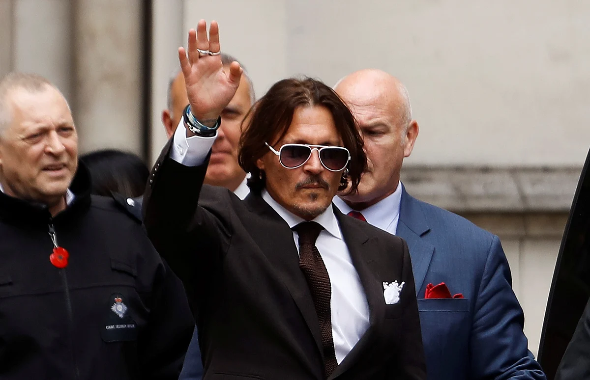 Actor Johnny Depp gestures as he leaves the High Court in London, Britain, 10 July 2020.