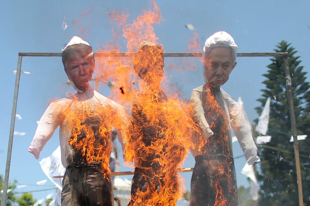 Hanged effigies depicting US president Donald Trump and Israeli prime minister Benjamin Netanyahu are burnt by Palestinian demonstrators during a protest against Israel's plan to annex parts of the Israeli-occupied West Bank, in Gaza City on 7 July 2020