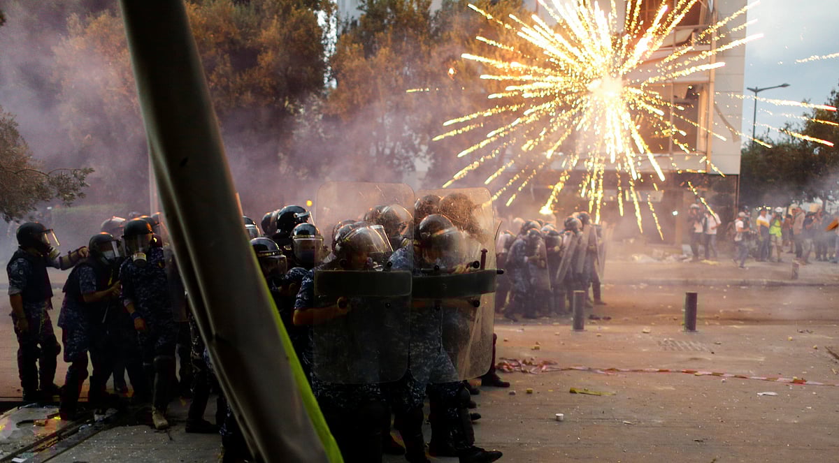 Fireworks are set off in front of police officers during anti-government protests that have been ignited by a massive explosion in Beirut, Lebanon 10 August, 2020.