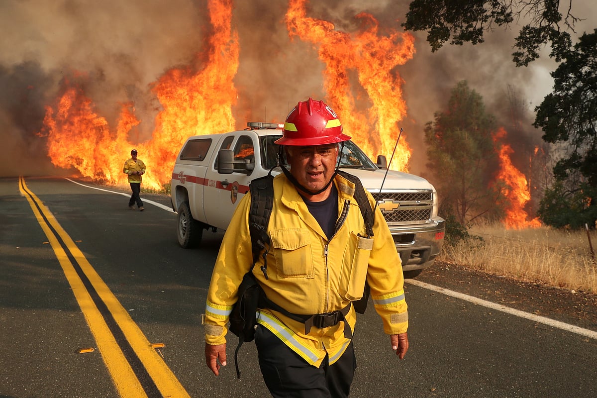 Chula Vista firefighter Rudy Diaz monitors the LNU Lightning Complex Fire as it engulfs brush in Lake County, California, US, 23 August  2020.