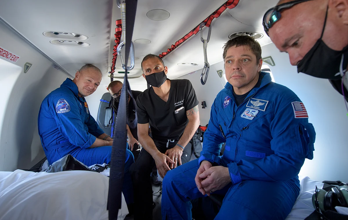 NASA astronauts Douglas Hurley (L) and Robert Behnken prepare to depart their helicopter at Naval Air Station Pensacola after the duo landed in their SpaceX Crew Dragon Endeavour spacecraft in the Gulf of Mexico off the coast of Pensacola, Florida, US, 2 August 2020. NASA/Bill Ingalls/Handout via Reuters