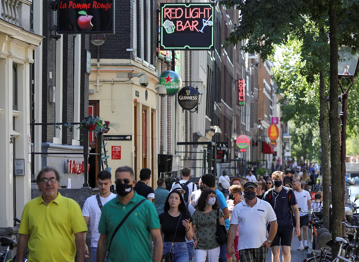 People with and without masks in the Red Light District in Amsterdam, Netherlands, 5 August 2020.