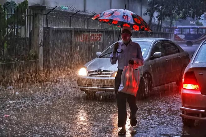 Cars turn headlights on as it gets dark during monsoon rains at Johnson Road, Dhaka on 4 August 2020.