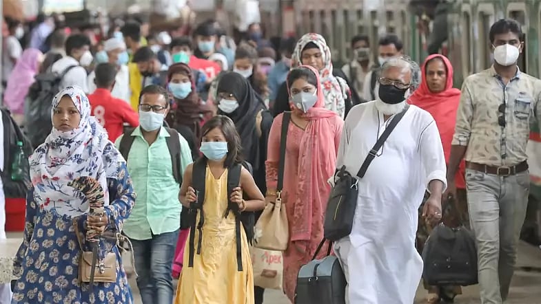 People walk along Kamalapur railway station defying physical distancing rules amid coronavirus spread in Dhaka on 16 August 2020.