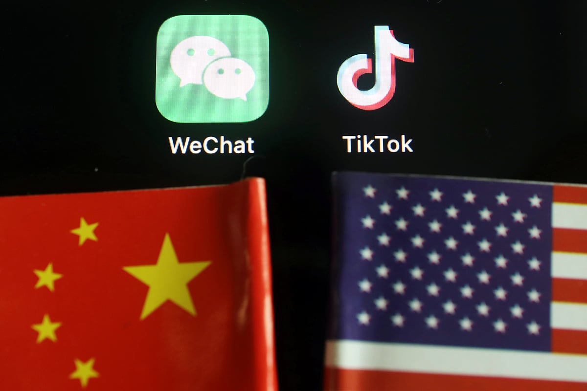 The messenger app WeChat and short-video app TikTok are seen near China and U.S. flags in this illustration picture taken on 7 August 2020