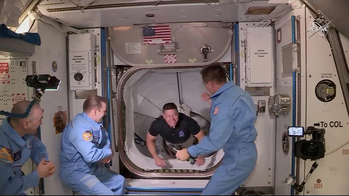 NASA astronaut Bob Behnken arrives at the International Space Station aboard SpaceX's Crew Dragon capsule in this still image taken from video, 31 May 2020.