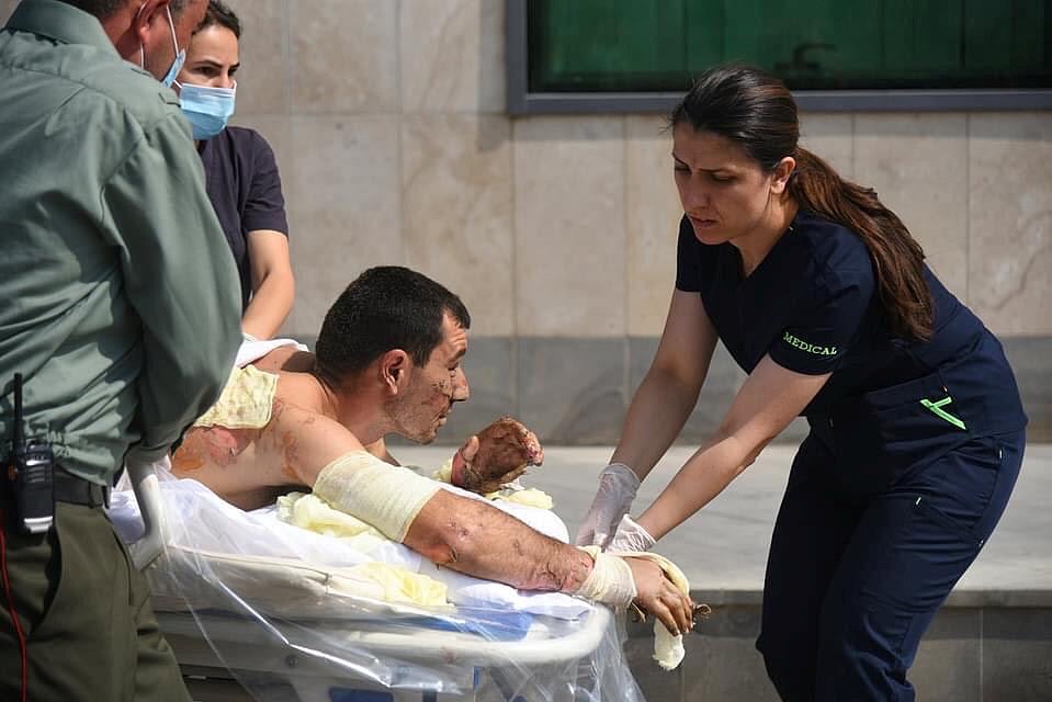 A handout photo released by the Armenian foreign ministry shows specialists delivering medical support to a man, who is said to be a civilian injured during clashes in the breakaway region of Nagorno-Karabakh, 27 September 2020.