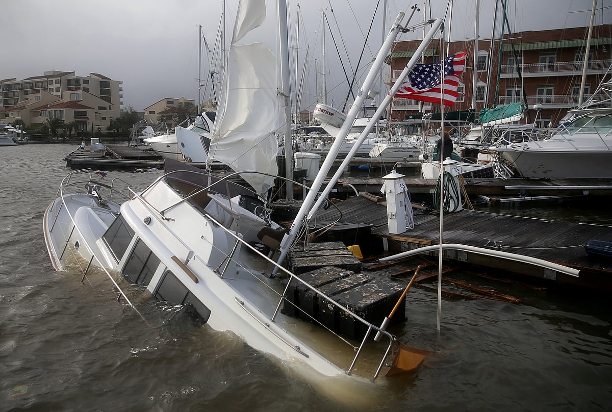 An US flag flies from a boat damaged by Hurricane Sally in Pensacola.