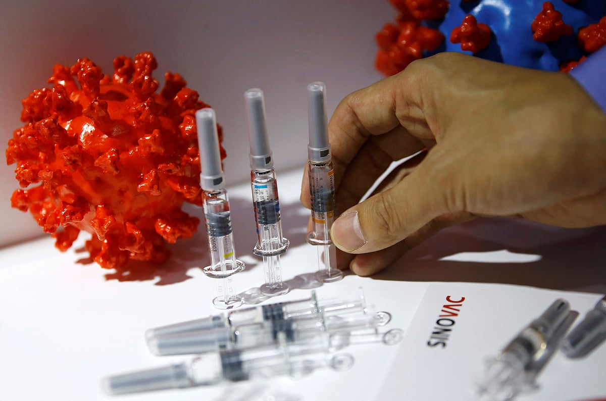 A staff member places a coronavirus vaccine candidate from Sinovac Biotech Ltd at its booth for display during the 2020 China International Fair for Trade in Services (CIFTIS), following the COVID-19 outbreak, in Beijing, China 5 September 2020