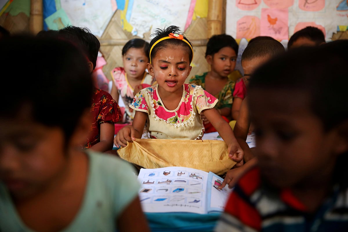 Rohingya refugee children attend a class to learn Burmese language at a refugee camp in Cox's Bazar, Bangladesh, 9 April 2019.