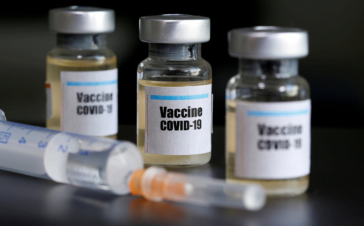 Small bottles labeled with a "Vaccine COVID-19" sticker and a medical syringe are seen in this illustration taken taken 10 April 2020.