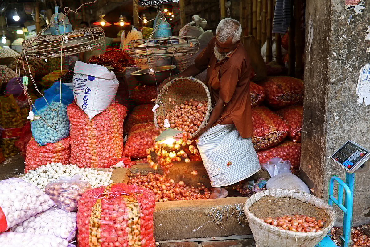 A man works at an onion wholesale market in the Kawran Bazar in Dhakaa, Bangladesh, on 24 July 2019