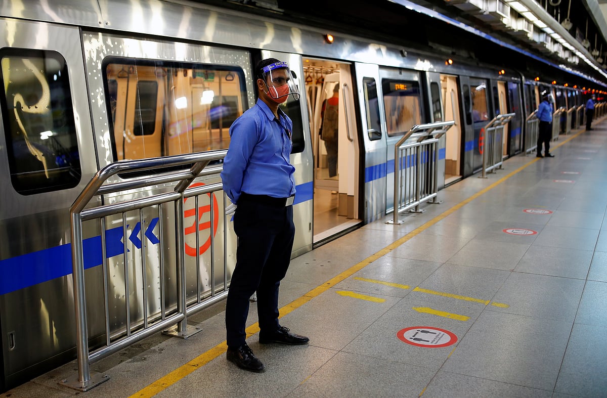 Security guards wearing face shields and masks stand outside a train at a Delhi Metro station ahead of the restart of its operations, amidst the spread of coronavirus disease (COVID-19), in New Delhi, India, on 3 September 2020
