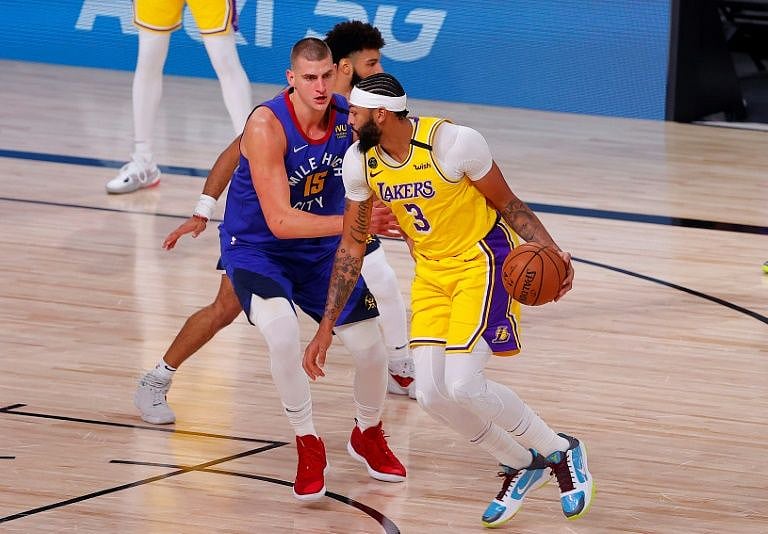 Los Angeles forward Anthony Davis drives past Denver's Nikola Jokic in the Lakers' 126-114 victory over the Nuggets in game one of the NBA Western Conference finals.