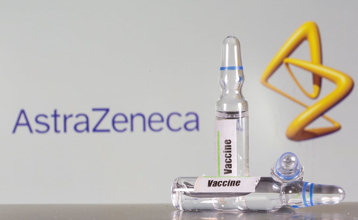 A test tube labeled with the vaccine is seen in front of AstraZeneca logo in this illustration taken, 9 September, 2020