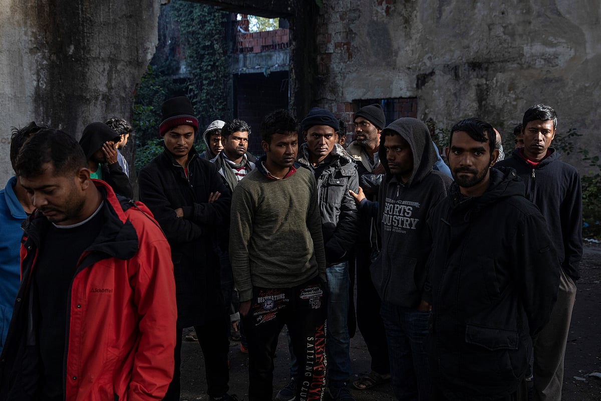 Migrants from Bangladesh stand inside an old abandoned factory near Velika Kladusa, Bosnia and Herzegovina, 30 September 2020. Hundreds of migrants from Asia, the Middle East and North Africa set up makeshift camps in Bosnian woods near the border with Croatia, attempting to cross into the European Union where they hope for a better life.