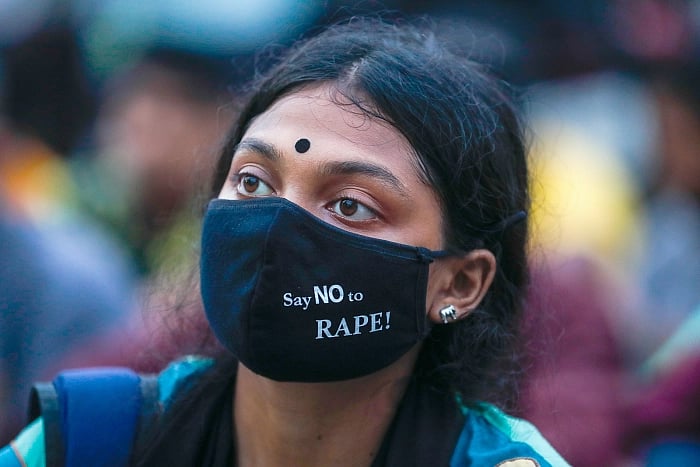 A demonstrator takes part in an anti-rape protest wearing a mask with the slogan 'Say no to rape' at Shahbagh, Dhaka on 12 October 2020.